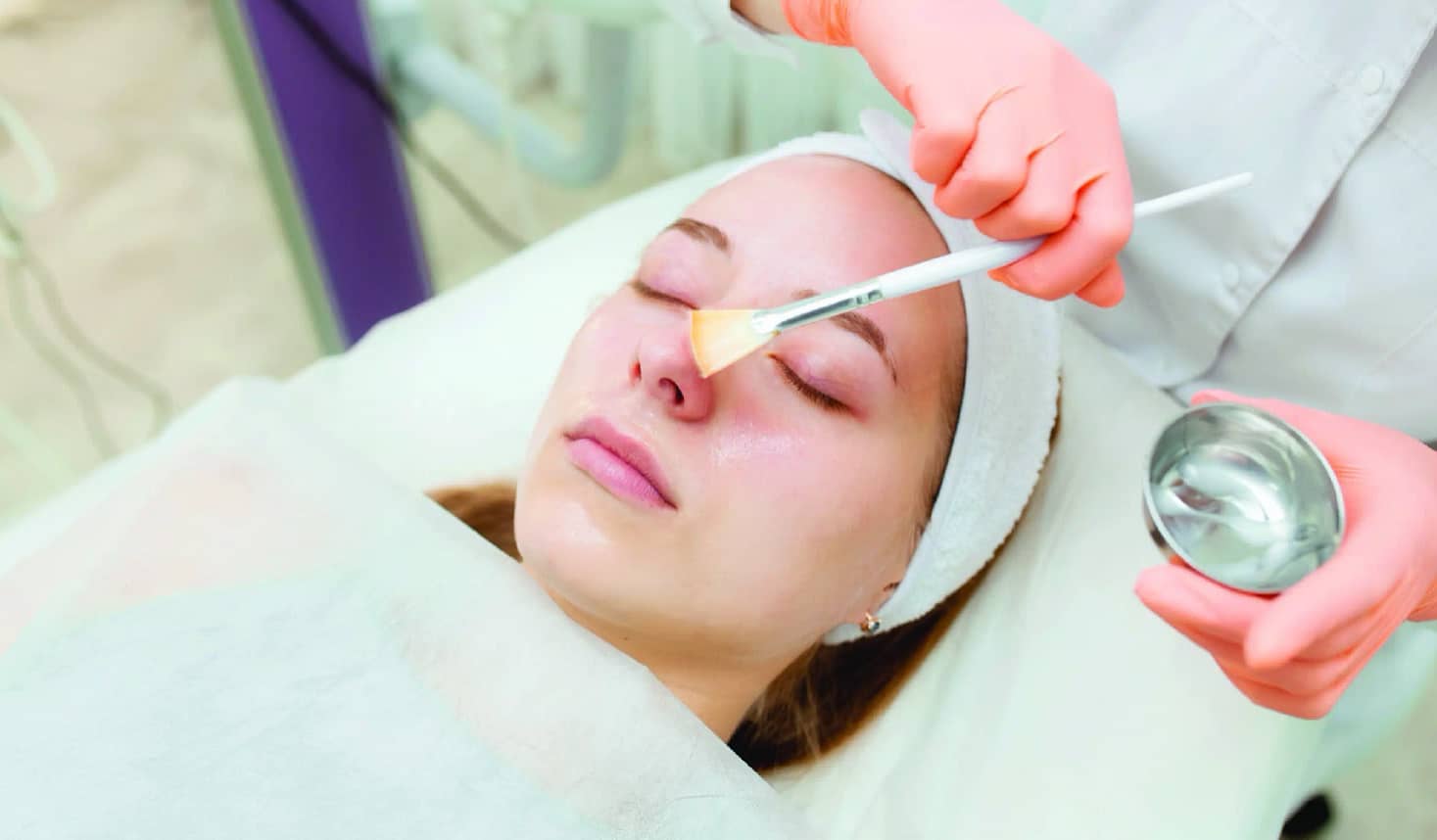 Woman undergoing a chemical peel treatment to rejuvenate their skin and reduce wrinkles.