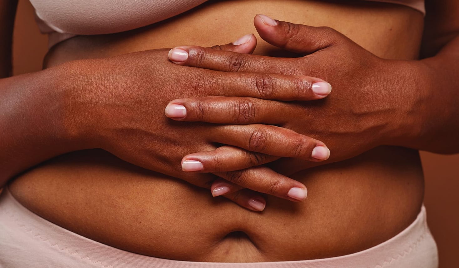 Woman with hands crossed Infront of stomach